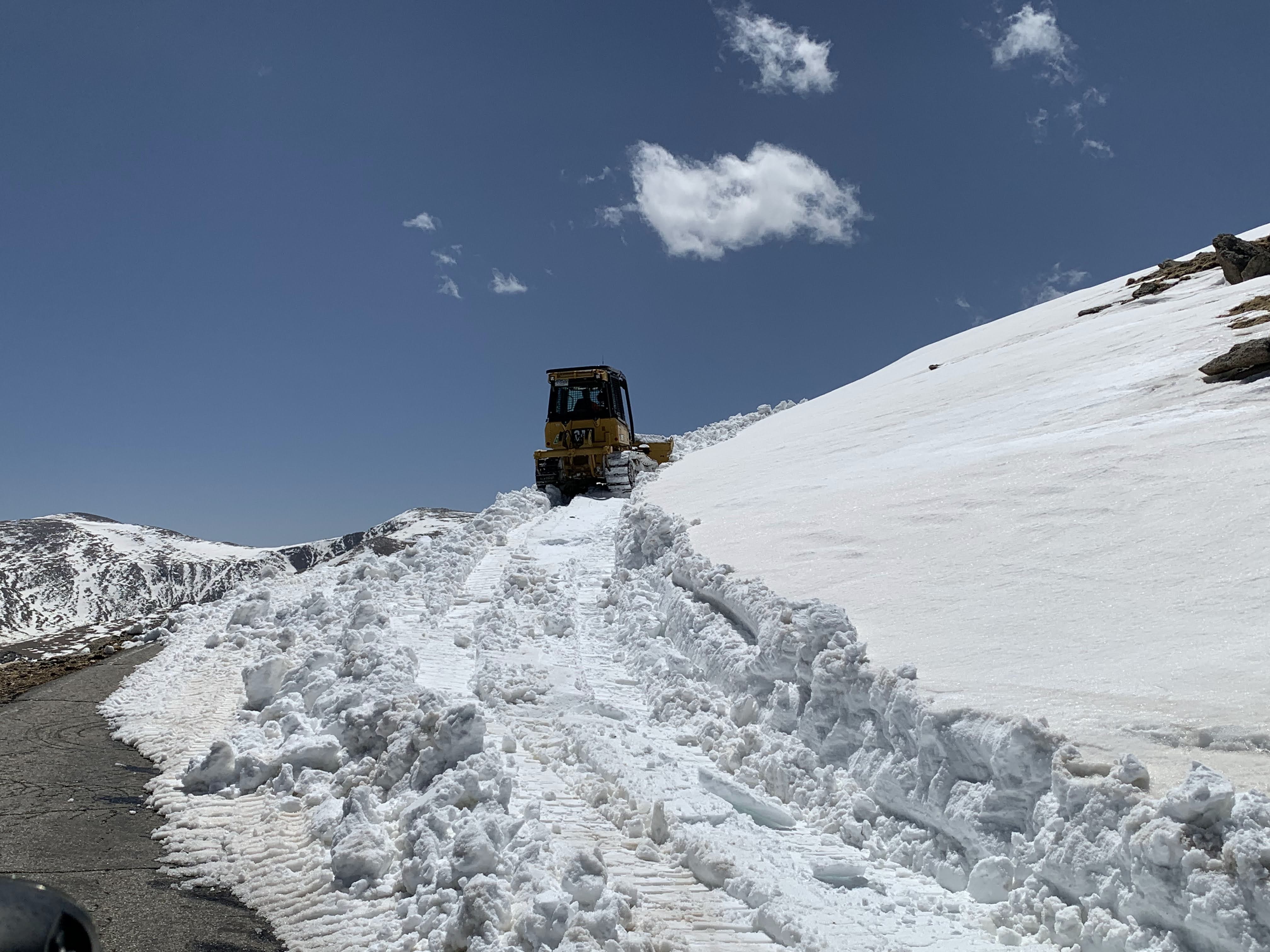 Tractor working to plow road on Mount Evans detail image