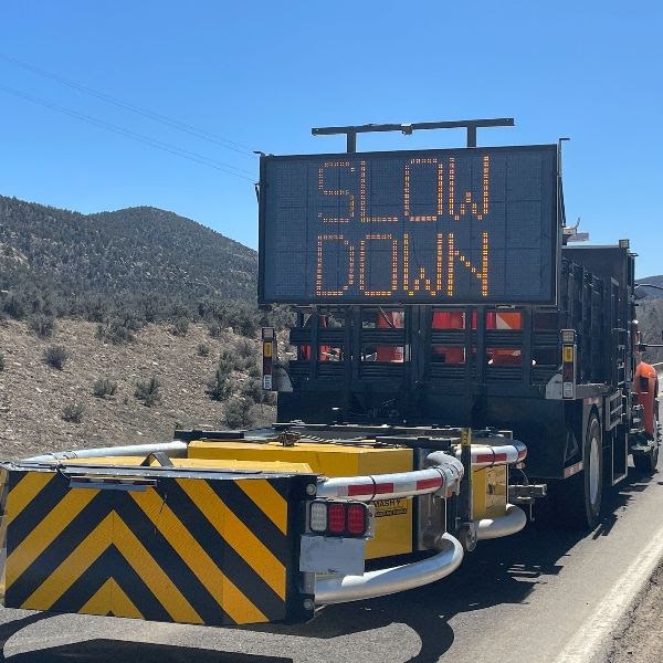 A portable VMS board alerts motorists to slow down ahead of highway maintenance operations. CDOT urges motorists to watch for workers and follow work zone speeds. 